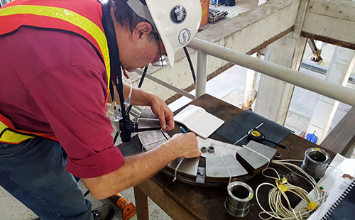 Pioneer engineer inspecting bearing and performing "bearing doctoring"