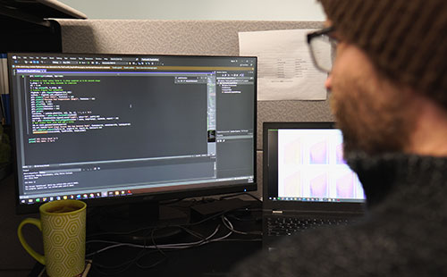 Pioneer member on a computer working on troubleshooting bearing solutions